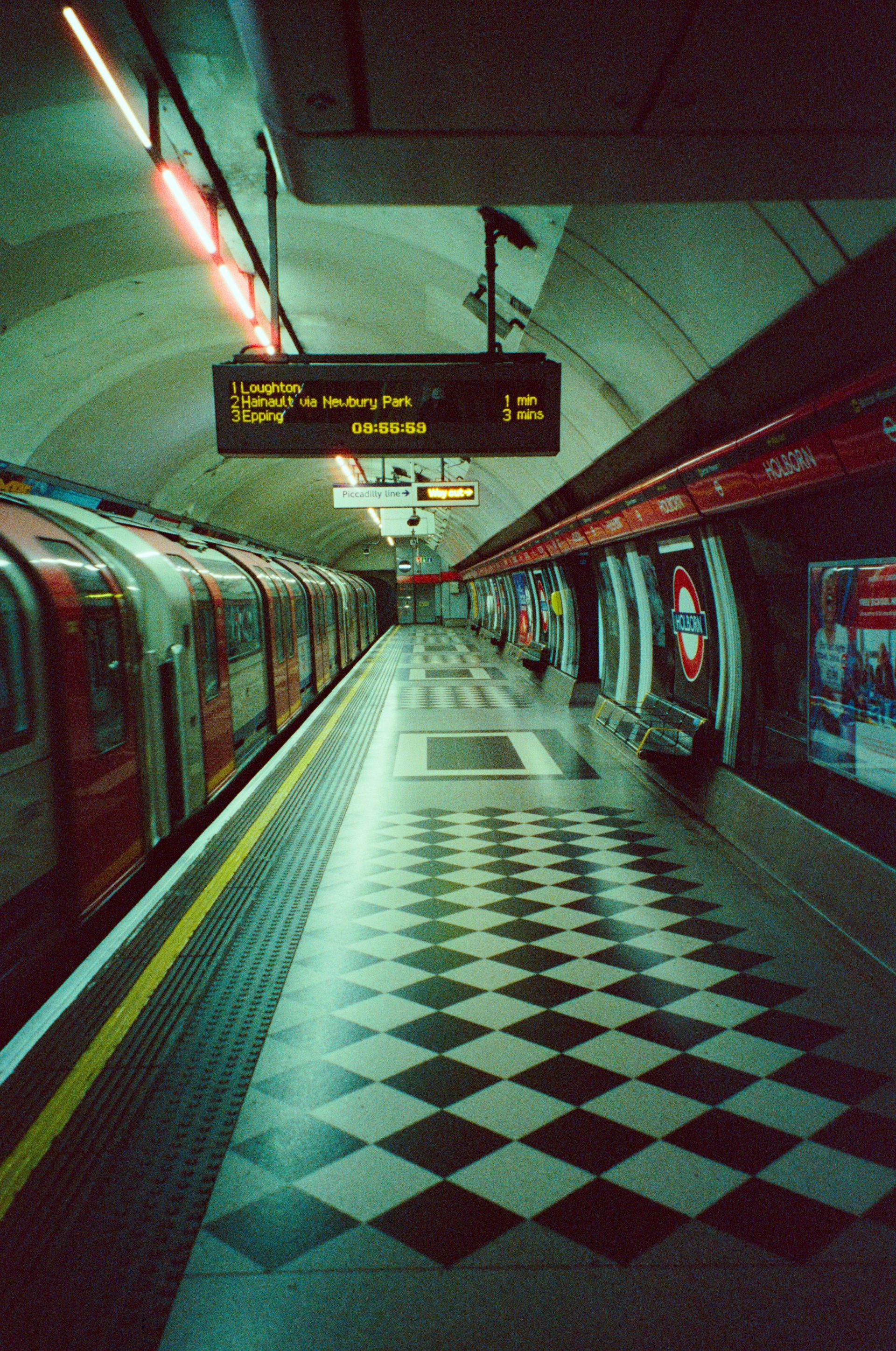 A train at a london underground station platform.